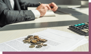 Cropped view of businessman writing in notebook near coins and petitions for bankruptcy on table, on